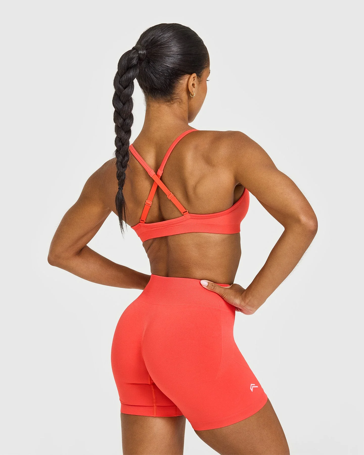 EnhanceLift™ Seamless Strappy Sports Bra with White Logo | Charged Coral - Image 2
