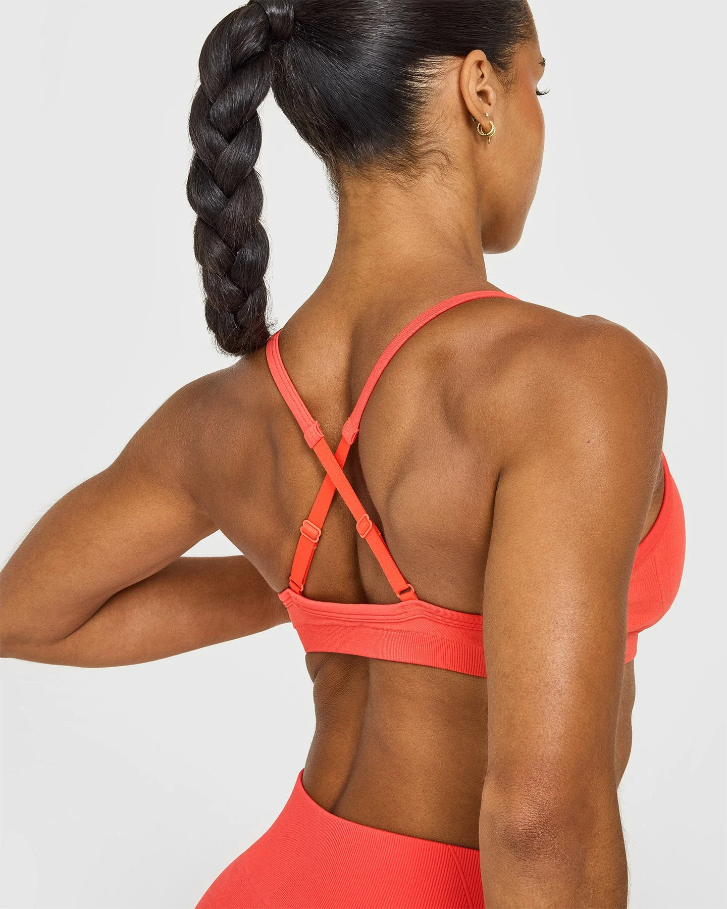 EnhanceLift™ Seamless Strappy Sports Bra with White Logo | Charged Coral - Image 4