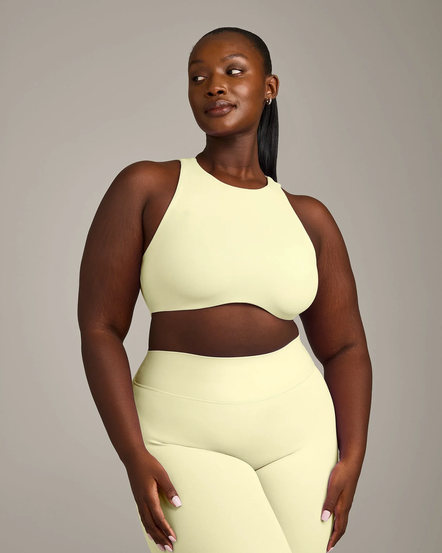 SoftMotion™ High Neck Sports Bra with Grey Logo | Pastel Yellow