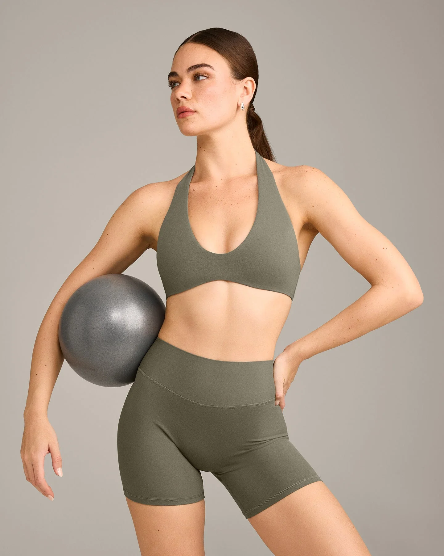 SoftMotion™ Minimal Halter Neck Bralette with Grey Logo | Alpine Green