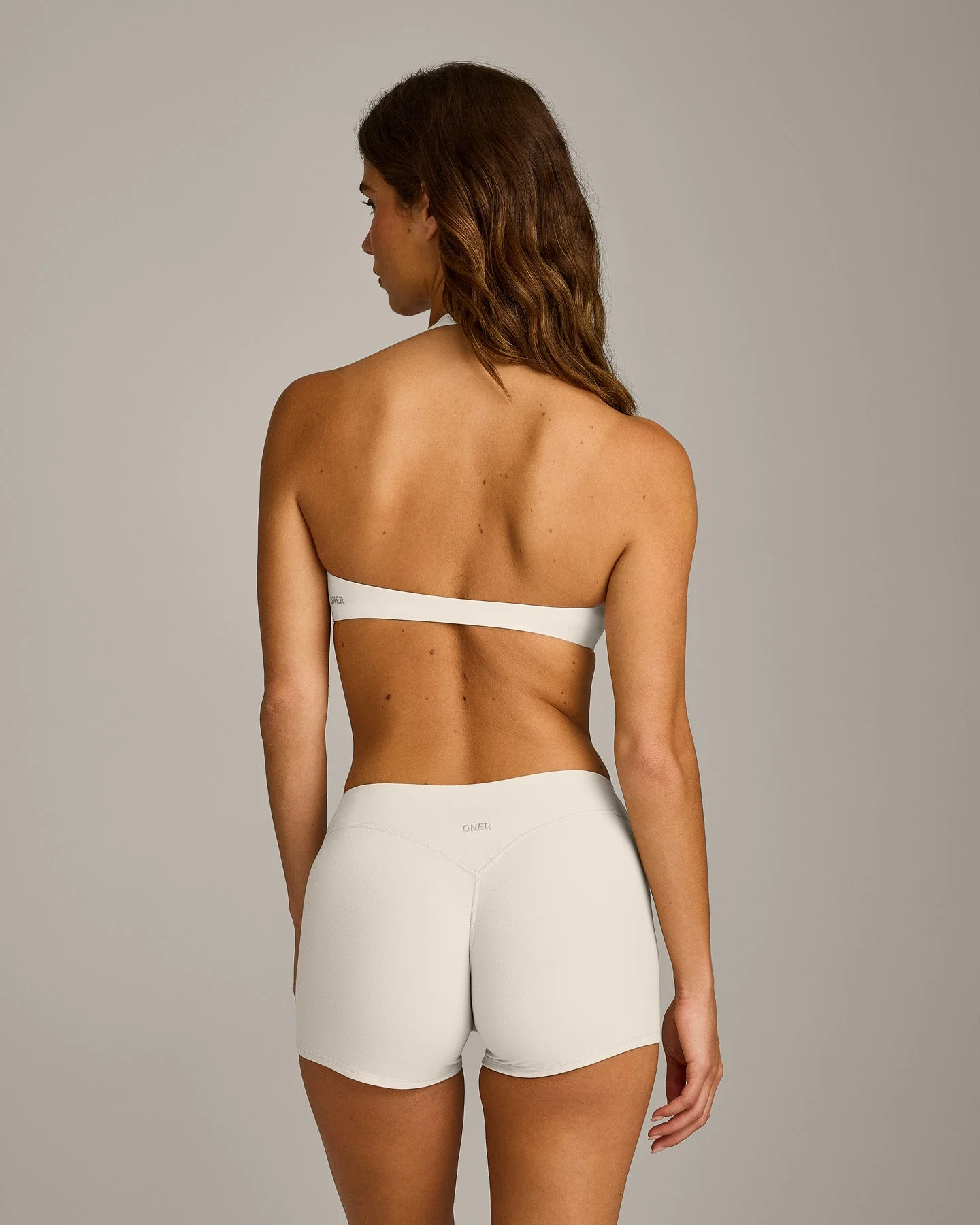 SoftMotion™ Minimal Halter Neck Bralette with Grey Logo | Marshmallow White - Image 6